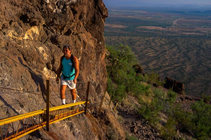 Hiker on the built-up portion of the summit trail to Picacho Peak, Arizona by Steve Bruno